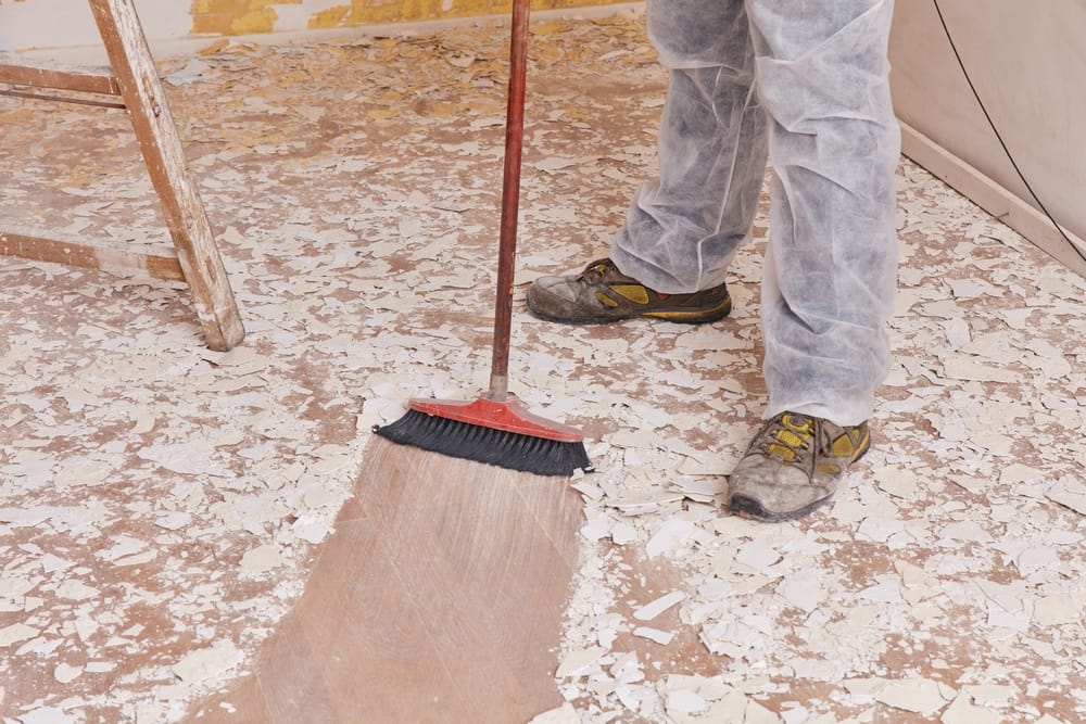 Builder,Sweeping,The,Floor,After,Renovation,Of,House