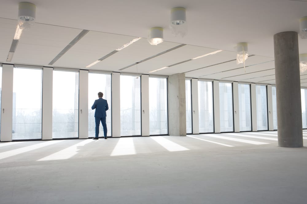 Rear,View,Of,Mature,Businessman,Visiting,Empty,Office,Space